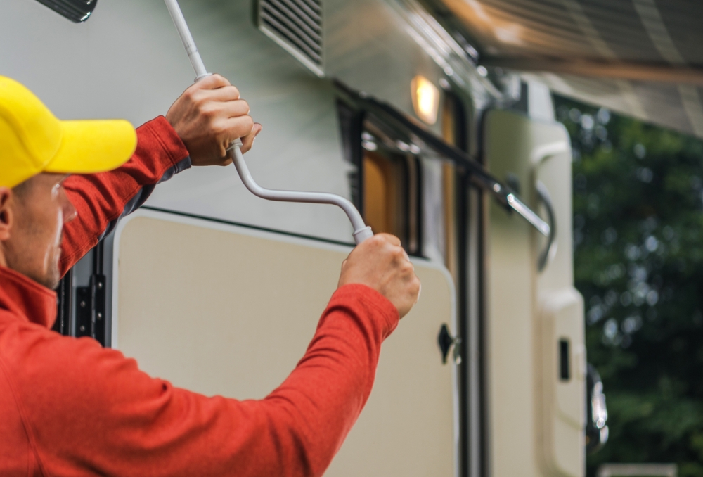 RV owner checking and maintaining equipment